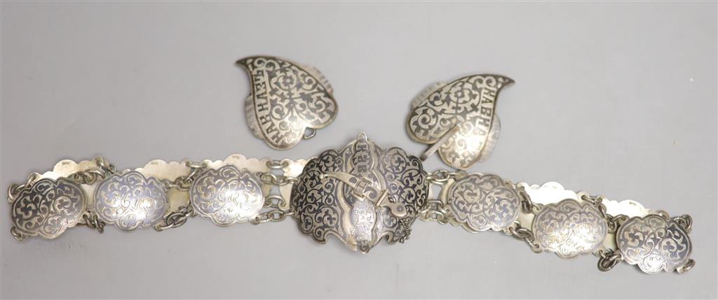 An early 20th century Russian white metal and niello belt, 74cm and a similar buckle, gross 5.5 oz.